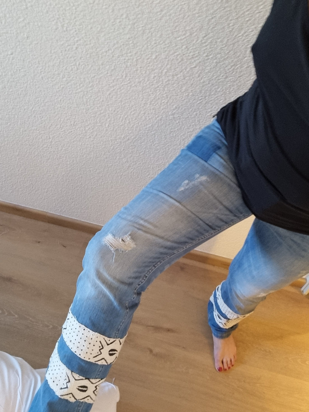Upcycled jeans with bogolan.